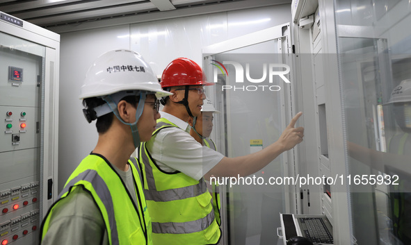 Technicians perform grid-connected power supply operations in a computer room in Liuzhou, China, on October 10, 2024. 