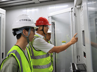 Technicians perform grid-connected power supply operations in a computer room in Liuzhou, China, on October 10, 2024. (