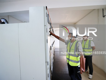 Technicians perform grid-connected power supply operations in a computer room in Liuzhou, China, on October 10, 2024. (