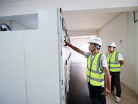 Technicians perform grid-connected power supply operations in a computer room in Liuzhou, China, on October 10, 2024. (