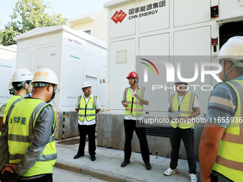 Engineers arrange tasks before grid connection for power supply in Liuzhou, China, on October 10, 2024. (