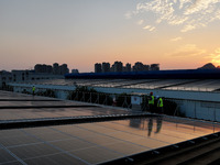 Technicians check photovoltaic power generation equipment before it is connected to the grid for power supply in Liuzhou, China, on October...