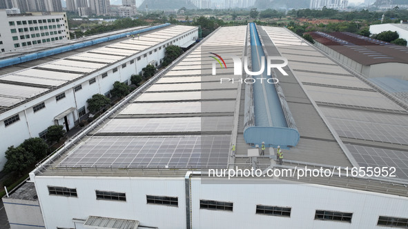 Technicians check photovoltaic power generation equipment before it is connected to the grid for power supply in Liuzhou, China, on October...