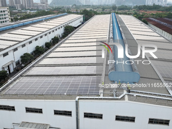 Technicians check photovoltaic power generation equipment before it is connected to the grid for power supply in Liuzhou, China, on October...