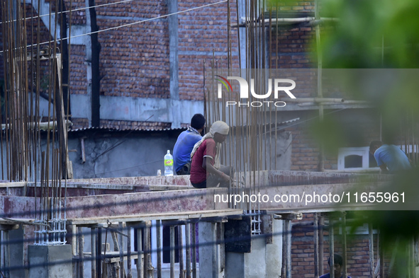 Workers work on a new building in Kirtipur, Kathmandu, Nepal, on October 7, 2024. 