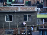 Workers work on a new building in Kirtipur, Kathmandu, Nepal, on October 7, 2024. (