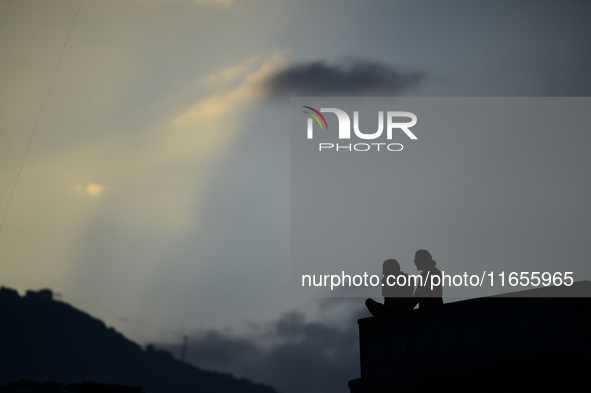 A silhouette of a couple enjoys the evening view in Kirtipur, Kathmandu, Nepal, on October 7, 2024. 