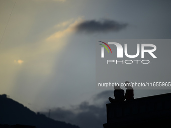 A silhouette of a couple enjoys the evening view in Kirtipur, Kathmandu, Nepal, on October 7, 2024. (