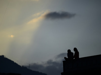 A silhouette of a couple enjoys the evening view in Kirtipur, Kathmandu, Nepal, on October 7, 2024. (