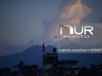 A Nepali domestic aircraft with passengers flies past a rainbow seen over the Nepali sky as it lands at Tribhuvan International Airport in K...