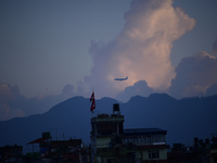 A Nepali domestic aircraft with passengers flies past a rainbow seen over the Nepali sky as it lands at Tribhuvan International Airport in K...