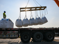 A crane transfers phthalic acid to a truck at the eastern operation area of Siyang Port on the Beijing-Hangzhou Grand Canal in Suqian, China...