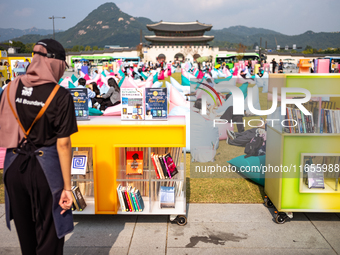 Citizens at the Gwanghwamun Square Book Fair in Seoul, South Korea, on October 11, 2024, view books by Han Kang, the South Korean author who...