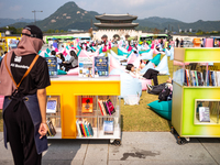 Citizens at the Gwanghwamun Square Book Fair in Seoul, South Korea, on October 11, 2024, view books by Han Kang, the South Korean author who...