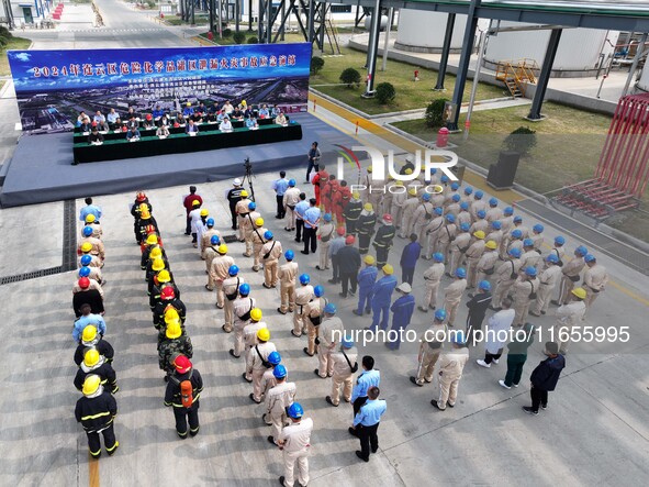 Participants gather during a fire emergency drill for a hazardous chemical tank farm leak in Lianyungang, Jiangsu province, China, on Octobe...