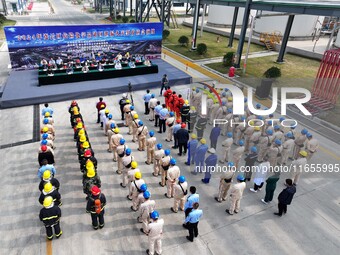 Participants gather during a fire emergency drill for a hazardous chemical tank farm leak in Lianyungang, Jiangsu province, China, on Octobe...