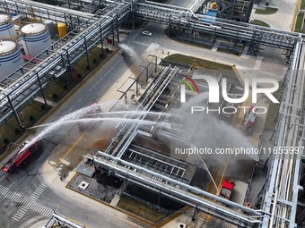 Firefighting equipment is deployed during an emergency drill for a leaking fire at a hazardous chemical tank farm in Lianyungang, Jiangsu pr...