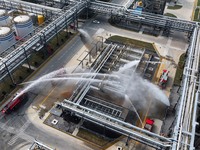 Firefighting equipment is deployed during an emergency drill for a leaking fire at a hazardous chemical tank farm in Lianyungang, Jiangsu pr...