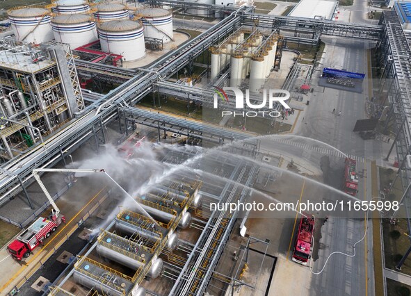 Firefighting equipment is deployed during an emergency drill for a leaking fire at a hazardous chemical tank farm in Lianyungang, Jiangsu pr...