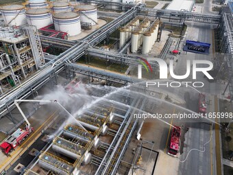 Firefighting equipment is deployed during an emergency drill for a leaking fire at a hazardous chemical tank farm in Lianyungang, Jiangsu pr...