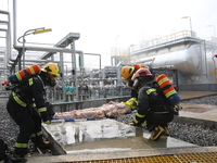 Rescue workers evacuate injured employees during an emergency drill for a fire accident involving a leaking hazardous chemical tank farm in...