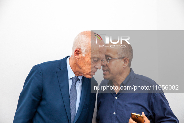 Presidential candidate Kais Saied talks with his brother Naoufel Saied at his campaign headquarters in Tunis, Tunisia, on September 17, 2019...