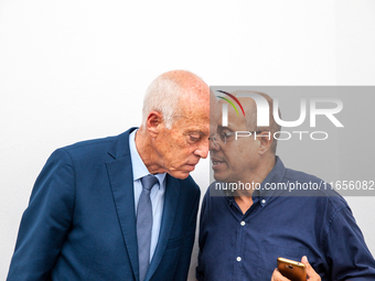 Presidential candidate Kais Saied talks with his brother Naoufel Saied at his campaign headquarters in Tunis, Tunisia, on September 17, 2019...