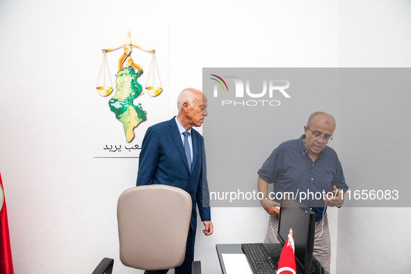 Presidential candidate Kais Saied talks with his brother Naoufel Saied at his campaign headquarters in Tunis, Tunisia, on September 17, 2019...