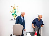 Presidential candidate Kais Saied talks with his brother Naoufel Saied at his campaign headquarters in Tunis, Tunisia, on September 17, 2019...