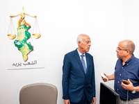 Presidential candidate Kais Saied talks with his brother Naoufel Saied at his campaign headquarters in Tunis, Tunisia, on September 17, 2019...