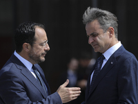 Greek Prime Minister Kyriakos Mitsotakis and Cyprus' President Nikos Christodoulides interact as they attend the 11th Summit of the Southern...