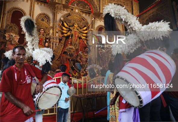 A Hindu priest prays in front of an idol of Durga, the Hindu goddess of power, during a ritual inside a ''pandal'' or temporary platform dur...