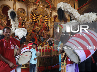 A Hindu priest prays in front of an idol of Durga, the Hindu goddess of power, during a ritual inside a ''pandal'' or temporary platform dur...