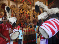 A Hindu priest prays in front of an idol of Durga, the Hindu goddess of power, during a ritual inside a ''pandal'' or temporary platform dur...