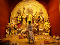 A Hindu priest holds a ''Chamor'' (white synthetic hair) with a brass handle used for Puja Aarti while praying in front of an idol of Durga...