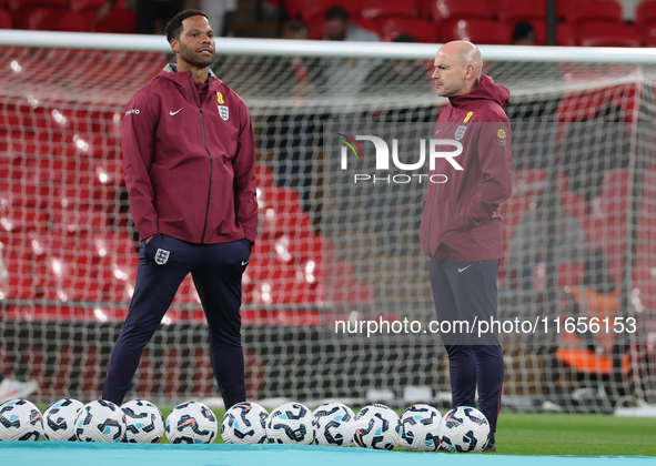 From left to right, Joleon Lescott, interim coach, and Lee Carsley, interim head coach of England, participate in the pre-match warm-up duri...