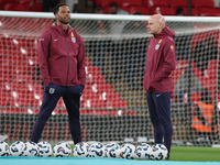 From left to right, Joleon Lescott, interim coach, and Lee Carsley, interim head coach of England, participate in the pre-match warm-up duri...