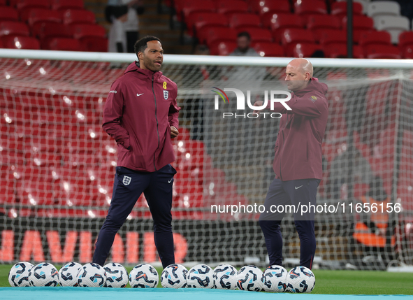 From left to right, Joleon Lescott, interim coach, and Lee Carsley, interim head coach of England, participate in the pre-match warm-up duri...