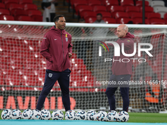 From left to right, Joleon Lescott, interim coach, and Lee Carsley, interim head coach of England, participate in the pre-match warm-up duri...