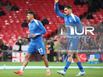 Dimitris Giannoulis of Greece and Ninos Mavropanos of Greece, from West Ham United, participate in the pre-match warm-up during the UEFA Nat...