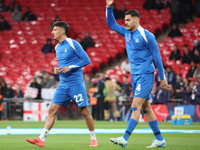 Dimitris Giannoulis of Greece and Ninos Mavropanos of Greece, from West Ham United, participate in the pre-match warm-up during the UEFA Nat...