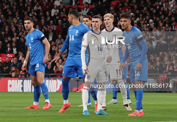 From left to right, Konstantinos Koullerakleof of Greece, Phil Foden of England, and Dimitris Giannouulis of Greece are in action during the...