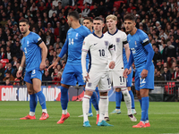 From left to right, Konstantinos Koullerakleof of Greece, Phil Foden of England, and Dimitris Giannouulis of Greece are in action during the...