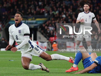 From left to right, Jude Bellingham of Real Madrid and England is tackled by Konstantinos Koullerakis of Greece during the UEFA Nations Leag...