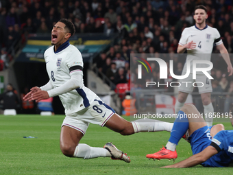 From left to right, Jude Bellingham of Real Madrid and England is tackled by Konstantinos Koullerakis of Greece during the UEFA Nations Leag...