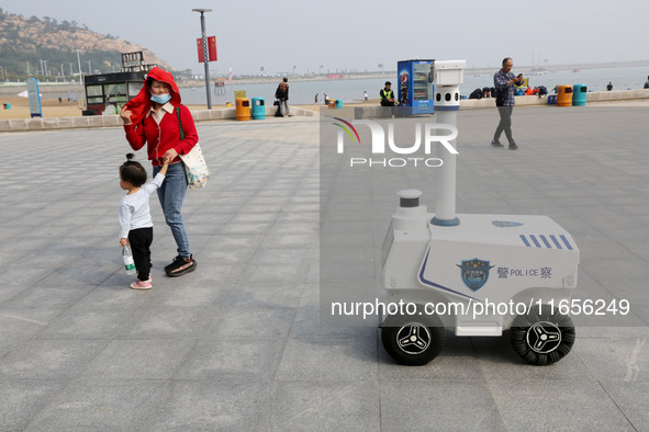 A public security intelligent security robot patrols a park in Lianyungang, China, on October 11, 2024. 