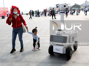 A public security intelligent security robot patrols a park in Lianyungang, China, on October 11, 2024. (