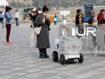 A public security intelligent security robot patrols a park in Lianyungang, China, on October 11, 2024. (