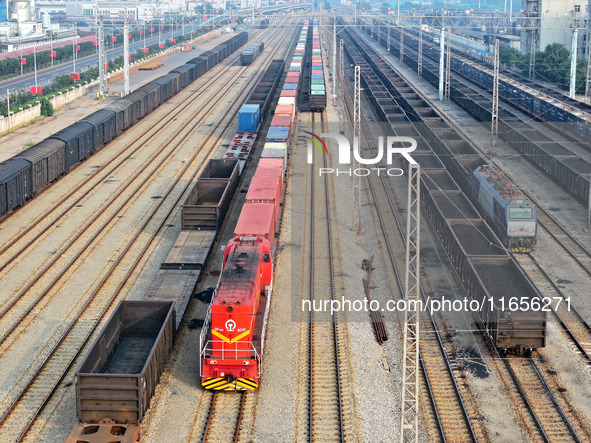 A cargo train prepares to depart at a railway marshalling station in Lianyungang, China, on October 11, 2024. 