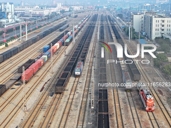 A cargo train prepares to depart at a railway marshalling station in Lianyungang, China, on October 11, 2024. (